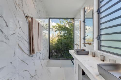 a bathroom with a sink and a window at Villa Regatta in Hato