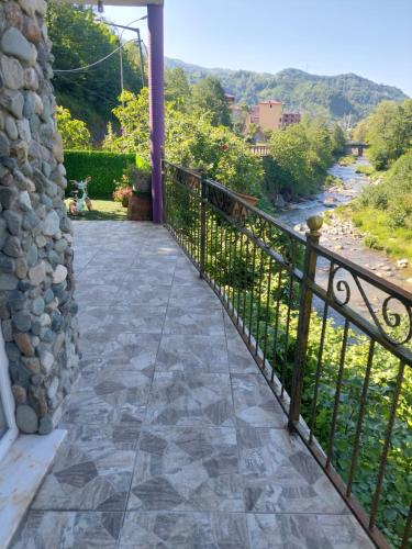 a balcony with a railing and a view of a river at Hânetül Mabeyn in Rize