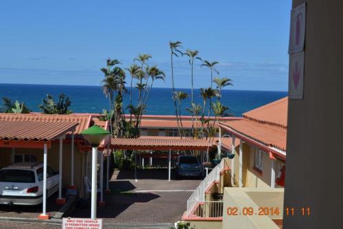 a view of a parking lot with the ocean in the background at Driftsands Sea View Flats in Uvongo Beach