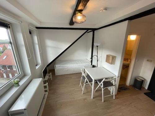 a small room with a table and a bed at Liebevoll eingerichtetes Ferienzimmer mit großen Garten in Clausthal-Zellerfeld