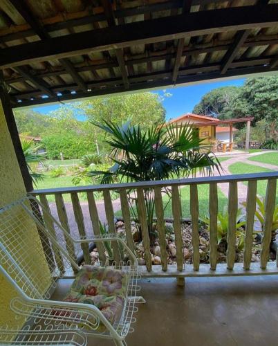 a balcony with a basket of fruit on a chair at Pousada Embaubas in Serra do Cipo