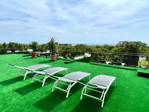 a group of chairs and tables on a green lawn at BSA Gradina Hotel & Aquapark - All Inclusive in Golden Sands