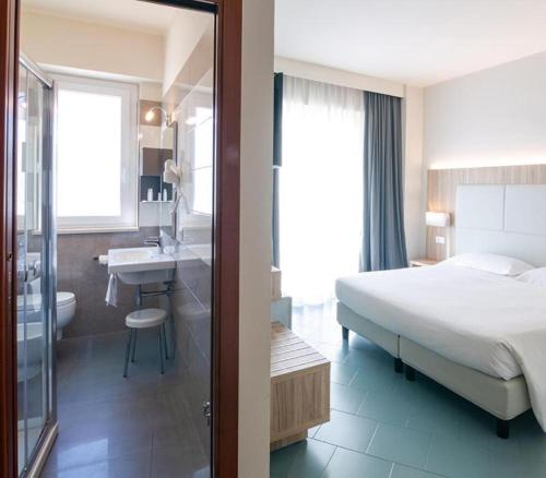 Postel nebo postele na pokoji v ubytování Hotel Meridiano