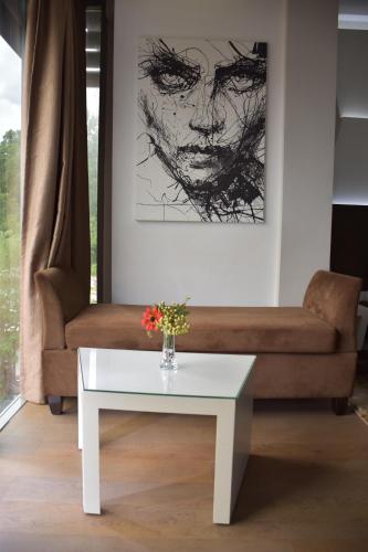 a living room with a couch and a white coffee table at New W Hotel in Tirana