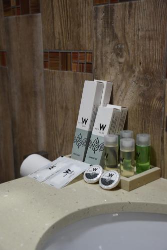 a bathroom counter with a bunch of items on it at New W Hotel in Tirana