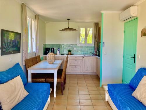 a kitchen with a table and chairs in a kitchen at Les Restanques 2268 glycines in Grimaud