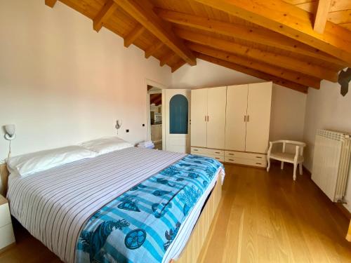a bedroom with a large bed in a room with wooden ceilings at A dream on the lake in Ranco