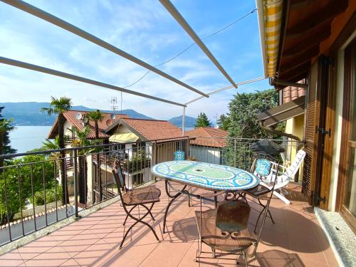 a patio with a table and chairs on a balcony at A dream on the lake in Ranco