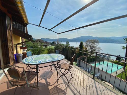 a balcony with a table and chairs and a view of the water at A dream on the lake in Ranco