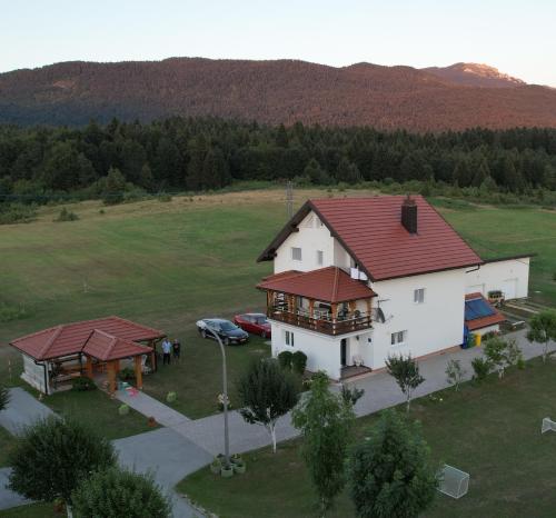 an aerial view of a white house with a red roof at House Pljesevica in Plitvička Jezera