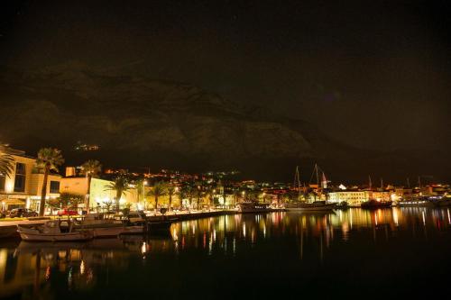 a harbor at night with boats in the water at Hotel Biokovo in Makarska