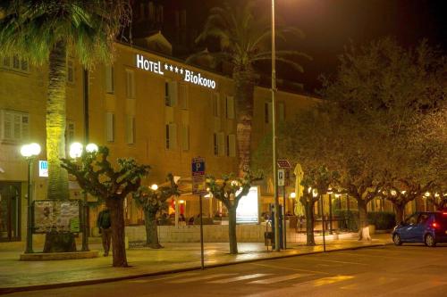 a street at night with a hotel with a bunch of trees at Hotel Biokovo in Makarska