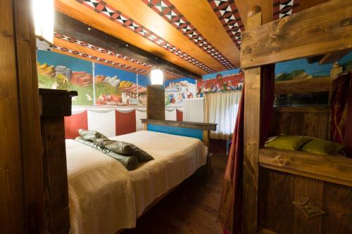 a bedroom with a bed in a room with a painting at Castello di Zumelle in Mel
