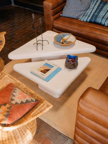 a table with two plates and a book on a tray at Pueblo Bonito Inn in Santa Fe