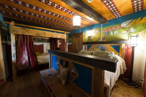 a room with a bed and a dog sitting next to it at Castello di Zumelle in Mel