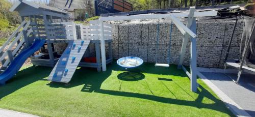 a playground with a slide and a swing at Apartamenty EDEN in Karpacz