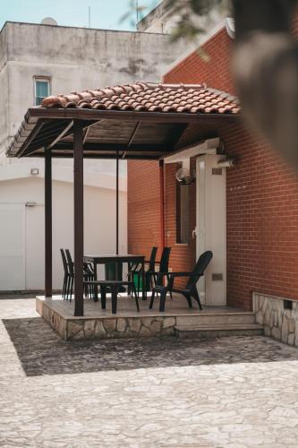 a patio with a table and chairs under a pavilion at Villa Gianna in Taranto