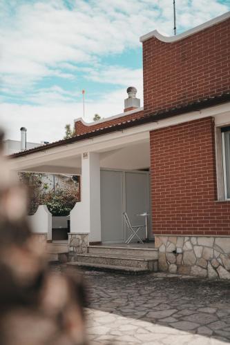 a red brick house with a window on the side of it at Villa Gianna in Taranto