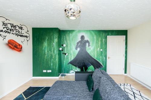a bedroom with a green wall with a woman in a dress at Escape The Matrix - 2 Bed Flat in City Centre with Free Parking in Southampton