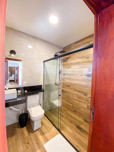 a bathroom with a toilet and a glass shower at Aiolos Hotel & Discoveries in Prea