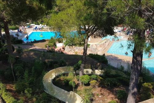 an aerial view of a water park with two pools at Dans un cadre d'exception, Vue mer panoramique à Agay Côte d'Azur, Village Vacances Cap Esterel, 2 chambres, avec jardin, golf, climatisation, Wifi, 5 piscines in Agay - Saint Raphael