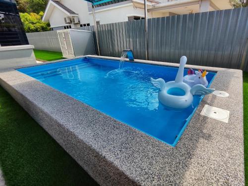 a swimming pool with a toy dolphin in the water at Homestay Temerloh with Private Pool Near Hospital 4 Bedroom 4 Aircond 10pax Free Wi-Fi Netflix in Temerloh