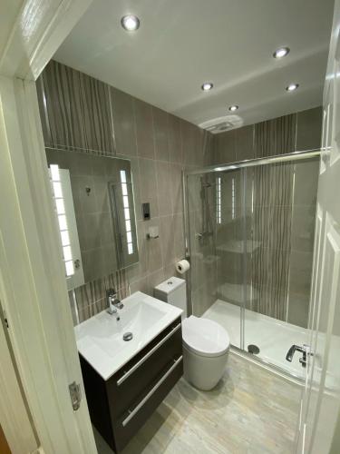 a bathroom with a toilet and a sink and a shower at Luxury Apartment APT4 in Wolverhampton