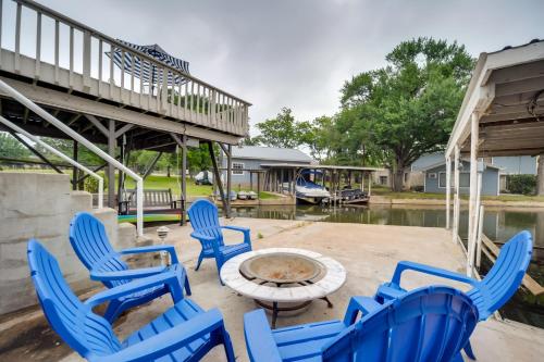 a group of blue chairs and a table on a patio at Lakefront Granite Shoals Escape with Dock! in Granite Shoals