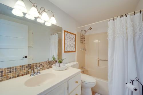 a bathroom with a sink and a toilet and a mirror at Lakefront Granite Shoals Escape with Dock! in Granite Shoals