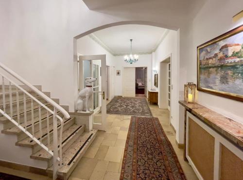 a hallway with stairs and a painting on the wall at Landhaus zu Kürenberg in Bergham