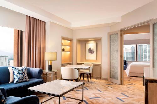 a hotel suite with a living room and a bedroom at Sheraton Imperial Kuala Lumpur Hotel in Kuala Lumpur