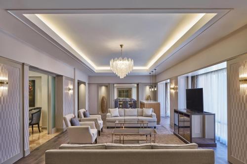 a living room with couches and a television at Sheraton Imperial Kuala Lumpur Hotel in Kuala Lumpur