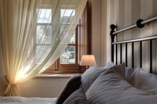 a bedroom with a bed and a window with at Agriturismo Nobile in Montepulciano