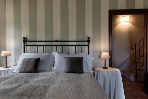 a bedroom with a large bed with two lamps at Agriturismo Nobile in Montepulciano