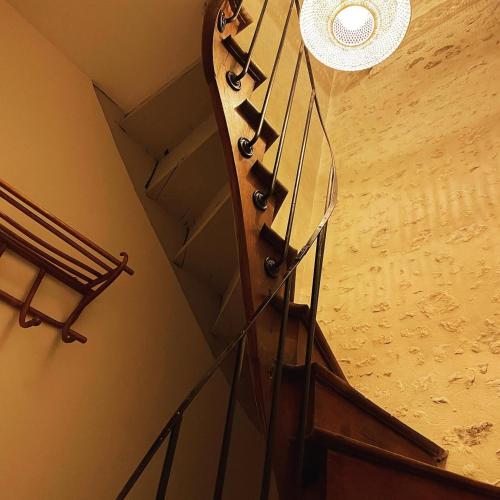 a glass staircase in a room with a ceiling at La Maison d'Horbé in La Perrière