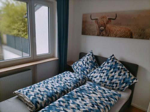 un sofá con almohadas y una foto de un toro en Ferienwohnung Luitpold 1, en Memmingen