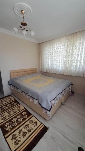 a bedroom with a bed in a room with a window at grand62 in Trabzon