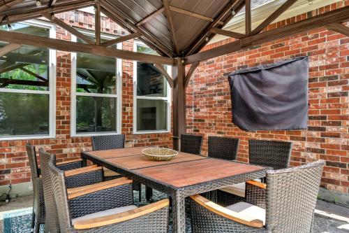 a wooden table and chairs on a patio at Taupewood Pl in The Woodlands