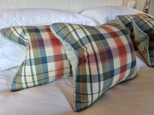 two pillows sitting on top of a bed at Craggan in Ballater