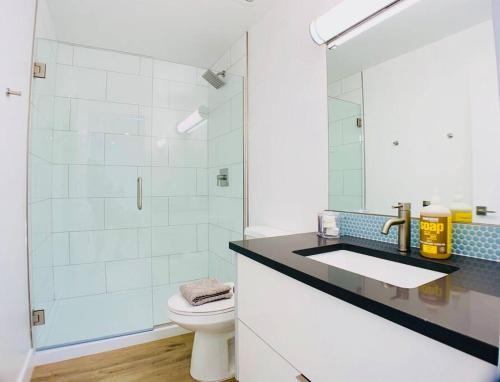 a bathroom with a toilet and a sink and a shower at Hidden Gem in OT Studio with Heated Pool in Scottsdale