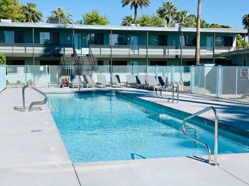 a swimming pool with chairs and a building at Hidden Gem in OT Studio with Heated Pool in Scottsdale