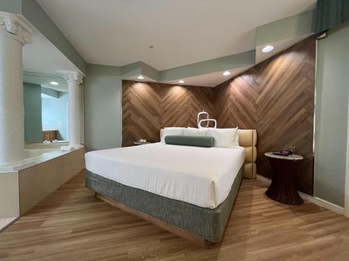 a bedroom with a large bed and a wooden wall at Star Island Resort and Club - Near Disney in Kissimmee
