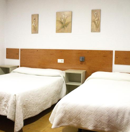Ένα ή περισσότερα κρεβάτια σε δωμάτιο στο Hostal Villa