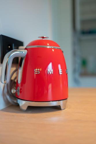 a red toaster sitting on top of a table at unique hideaway, holiday house with large garden in Kortenaken
