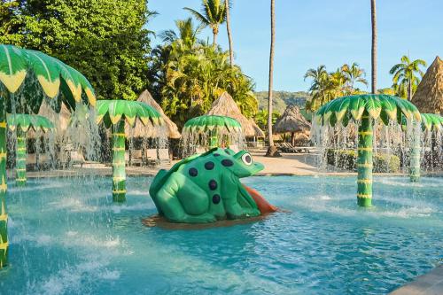 a pool at a resort with a frog in the water at Barceló Tambor - All Inclusive in Tambor