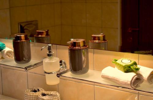 a bathroom with two bottles of soap and a mirror at Carmen Art Hotel in Rhodes Town