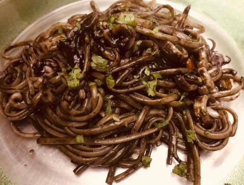 a plate of food with noodles on a table at CINQUE OTTAVI B&B in Santa Marinella