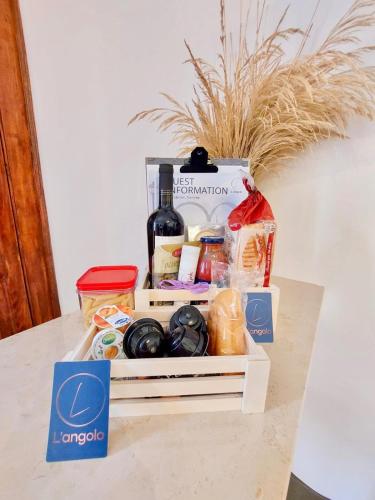 a drawer filled with food and a bottle of wine at Gemelli in Petacciato