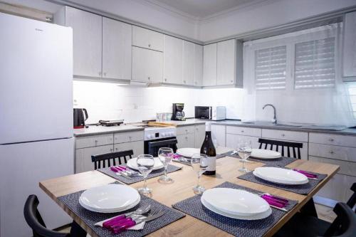 a kitchen with a table with plates and wine glasses at Levante Breeze in Xirokástellon