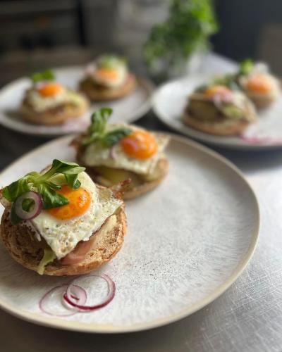 a plate of food with egg sandwiches on a table at Pensjonat Zakątek in Lidzbark